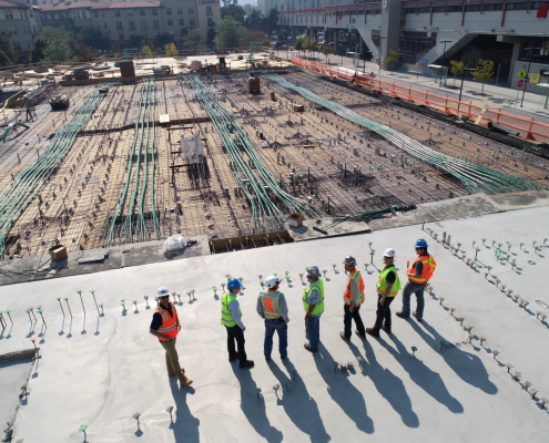 Seven workers overlooking a construction site